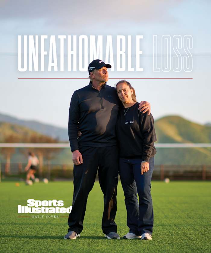 Steve and Gina Meyer stand together on a soccer field.